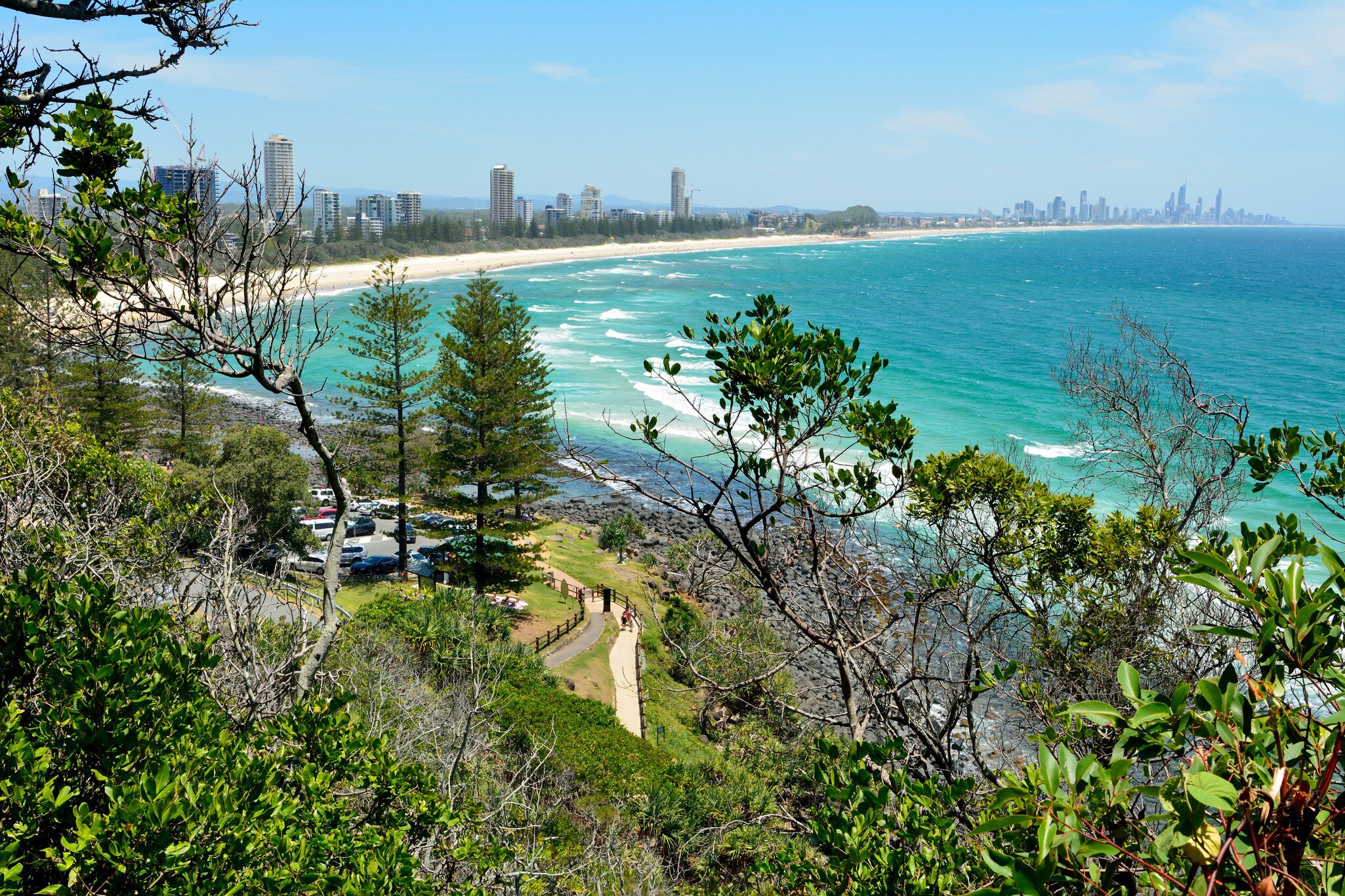 Burleigh Heads, Gold Coast, Queensland, Australia. View from Burleigh Heads National Park, toward Surfers Paradise, with buildings, cars, vegetation and people.
