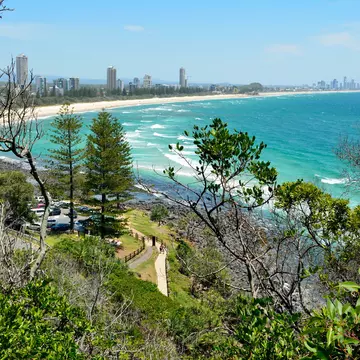 Burleigh Heads, Gold Coast, Queensland, Australia. View from Burleigh Heads National Park, toward Surfers Paradise, with buildings, cars, vegetation and people.