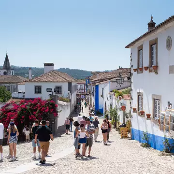 People on a main shopping street of a small town.