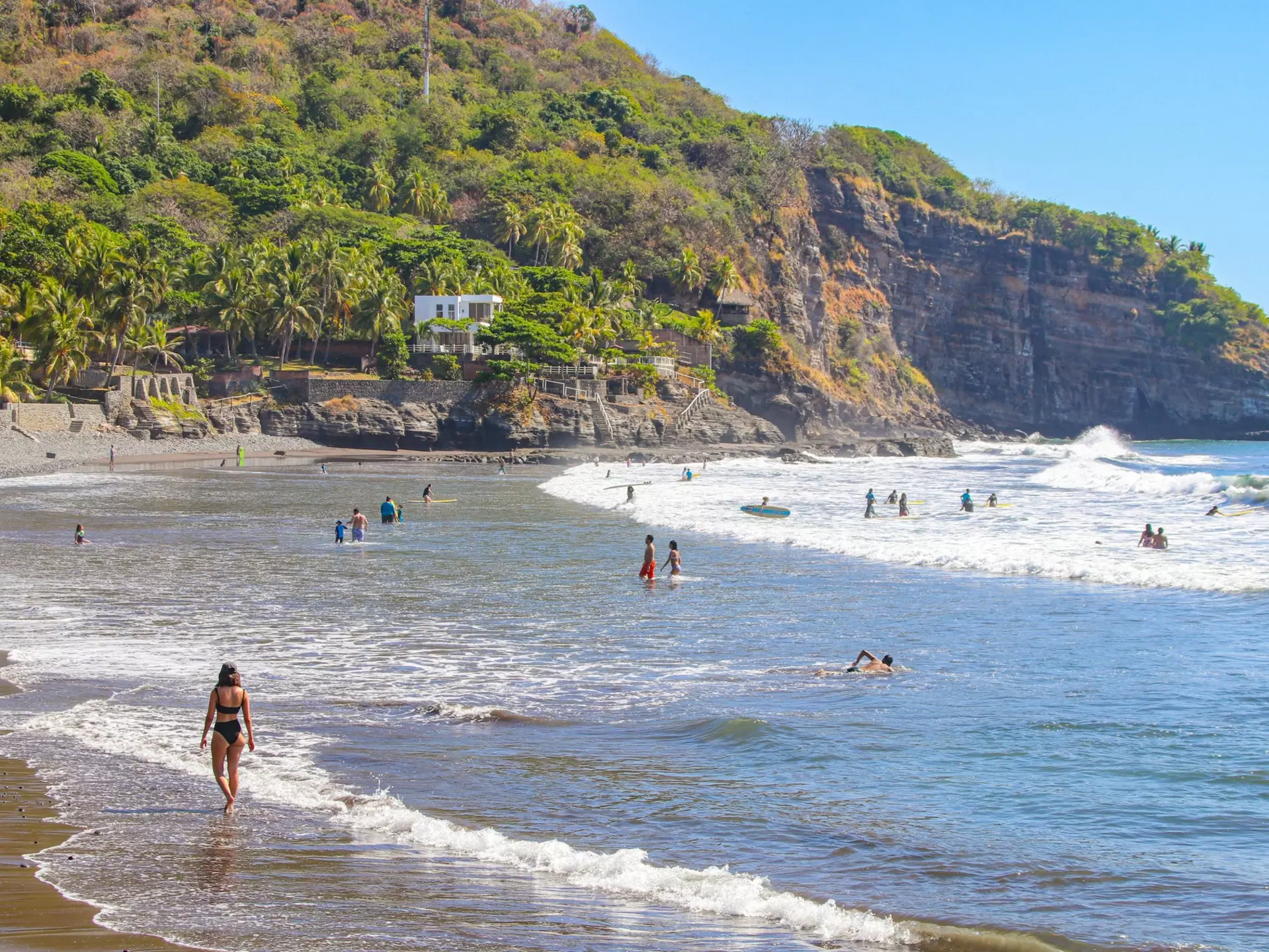 People enjoying the beach in El Tunco, El Salvador.
