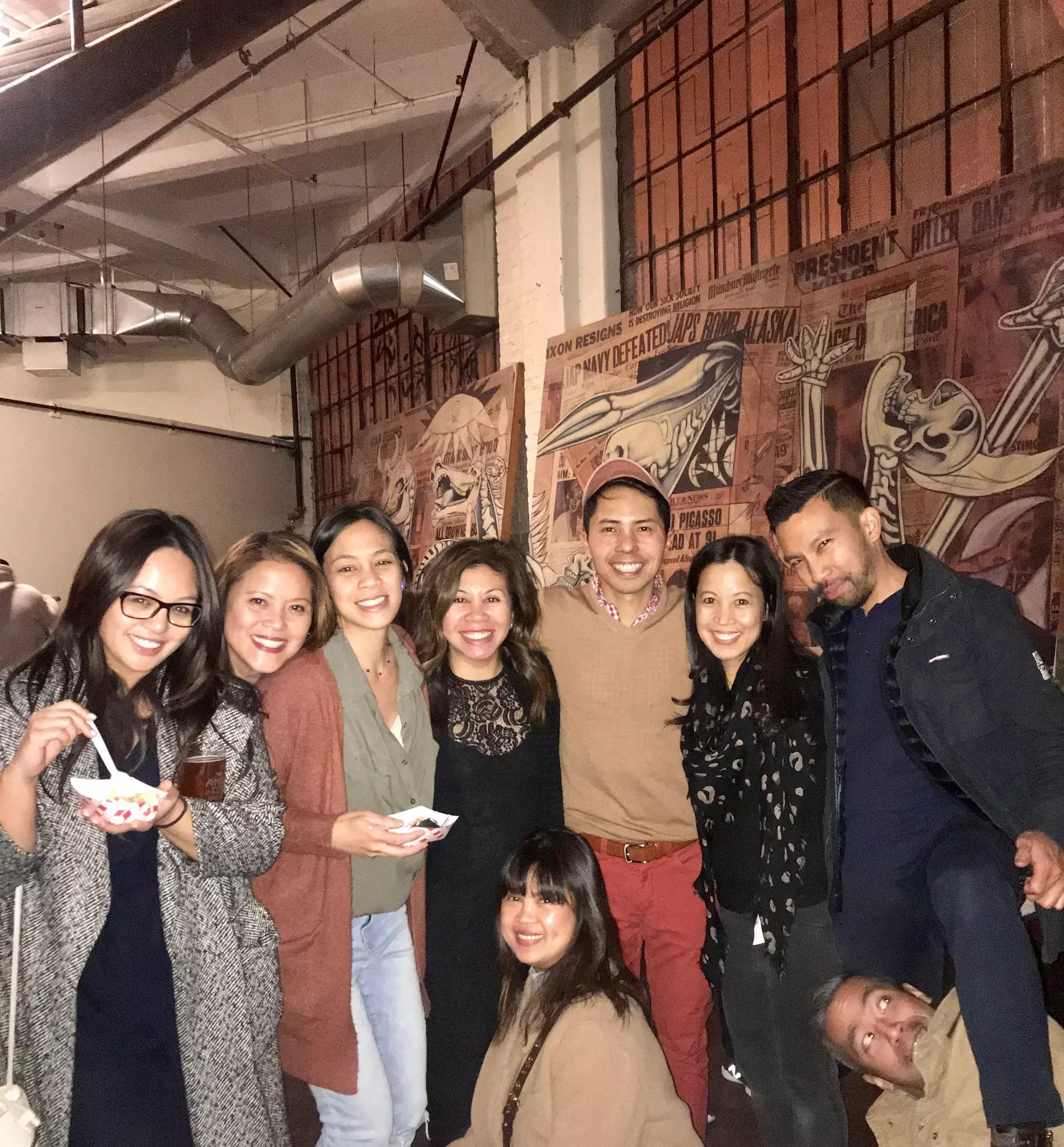 A group of people pose for a photo in a restaurant.