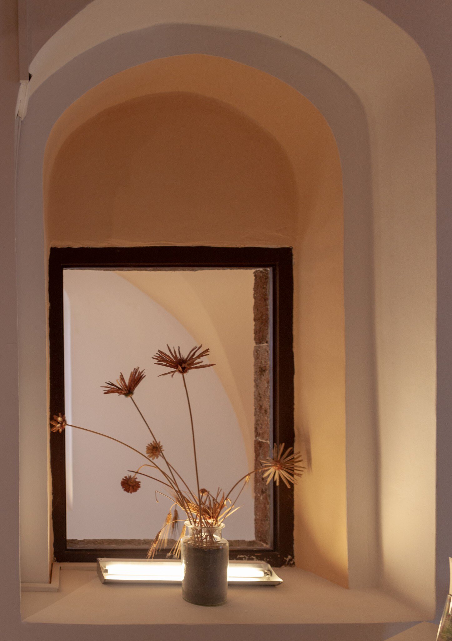 A vase with flowers from the 2018 art collection at the Gyzi Megaron Museum in Fira, Santorini.