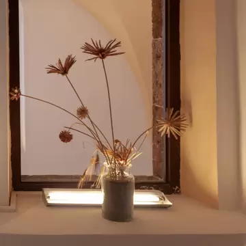 A vase with flowers from the 2018 art collection at the Gyzi Megaron Museum in Fira, Santorini.