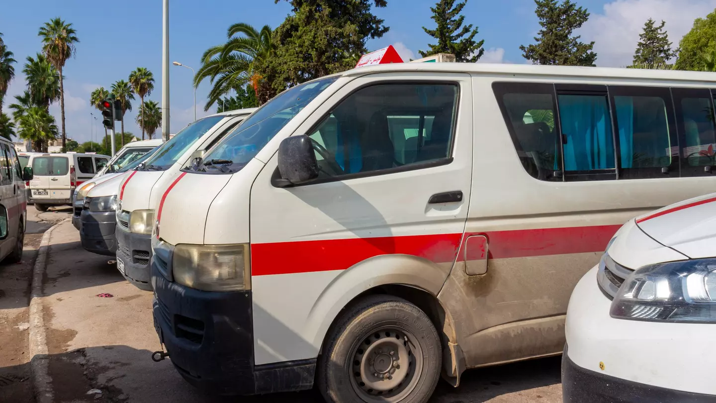 Louages (shared minivans) waiting for passengers in Tunisia.