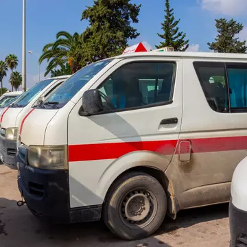 Louages (shared minivans) waiting for passengers in Tunisia.