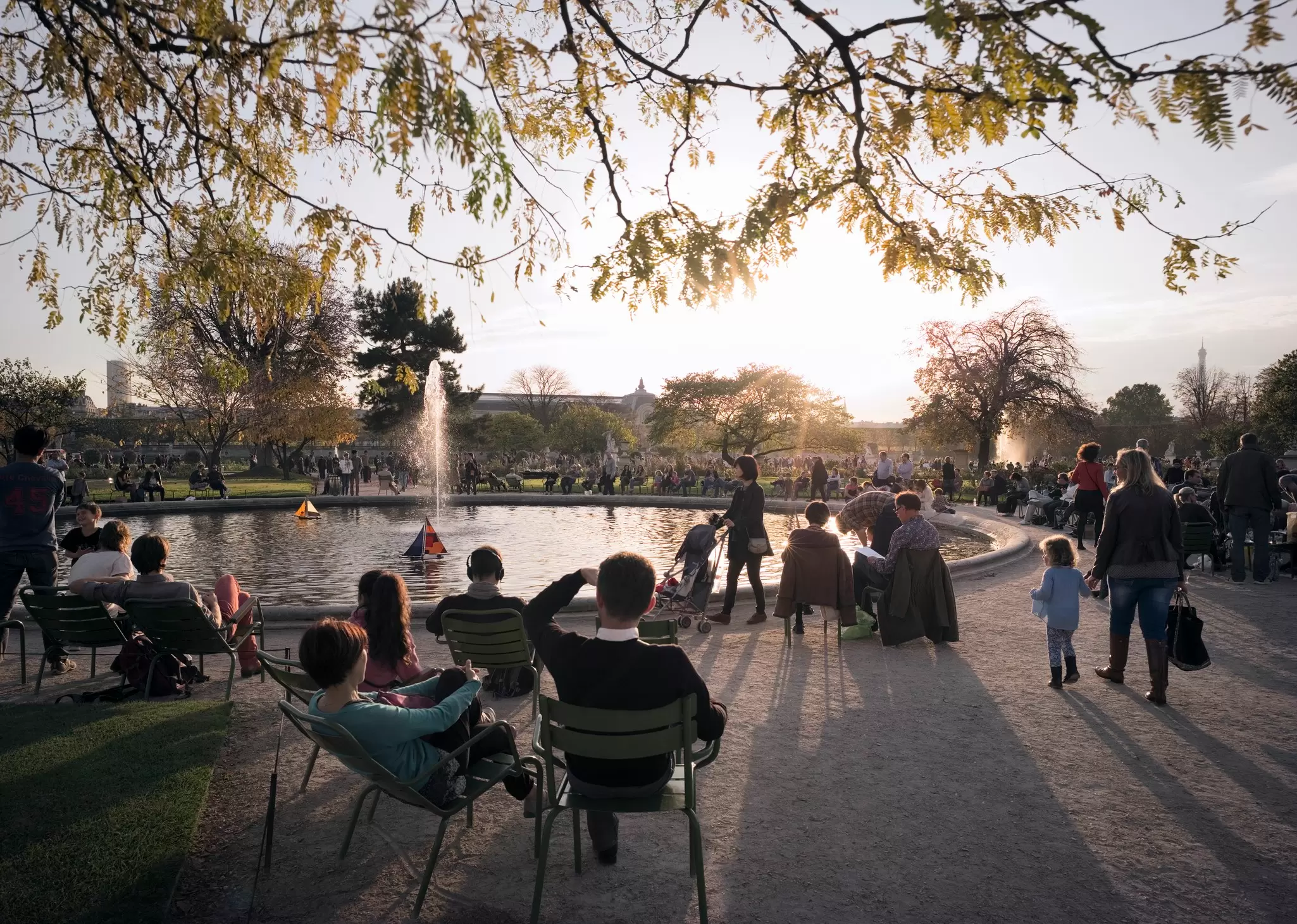 People enjoying an autumn day at the Jardin des Tuileries in Paris