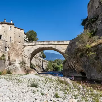 Vaison-la-Romaine, Vaucluse department,  Provence-Alpes-Côte d'Azur, France. The Pont Romain over the River Ouveze on sunny summer afternoon.