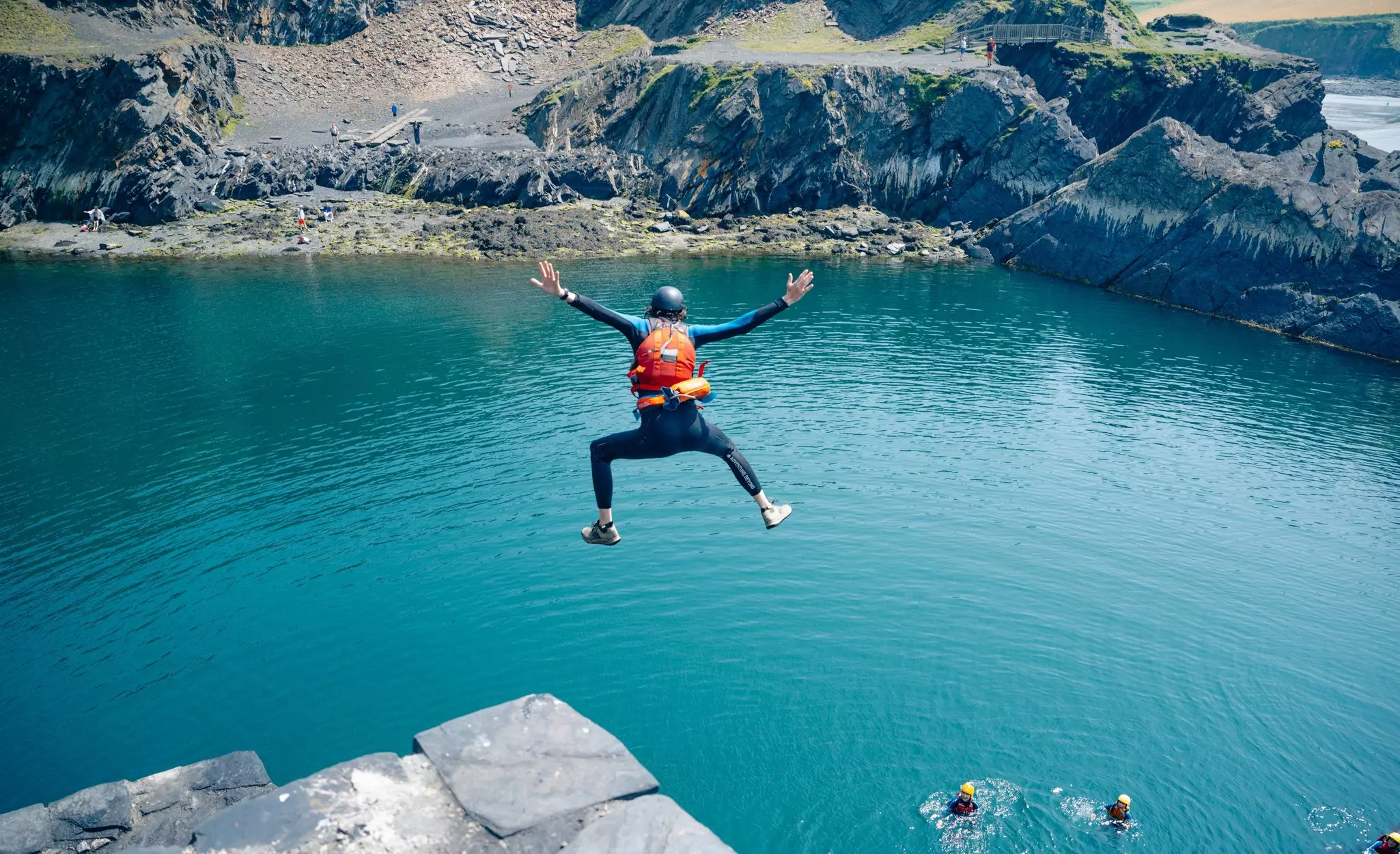 Man coasteering jumping into the Blue Lagoon.