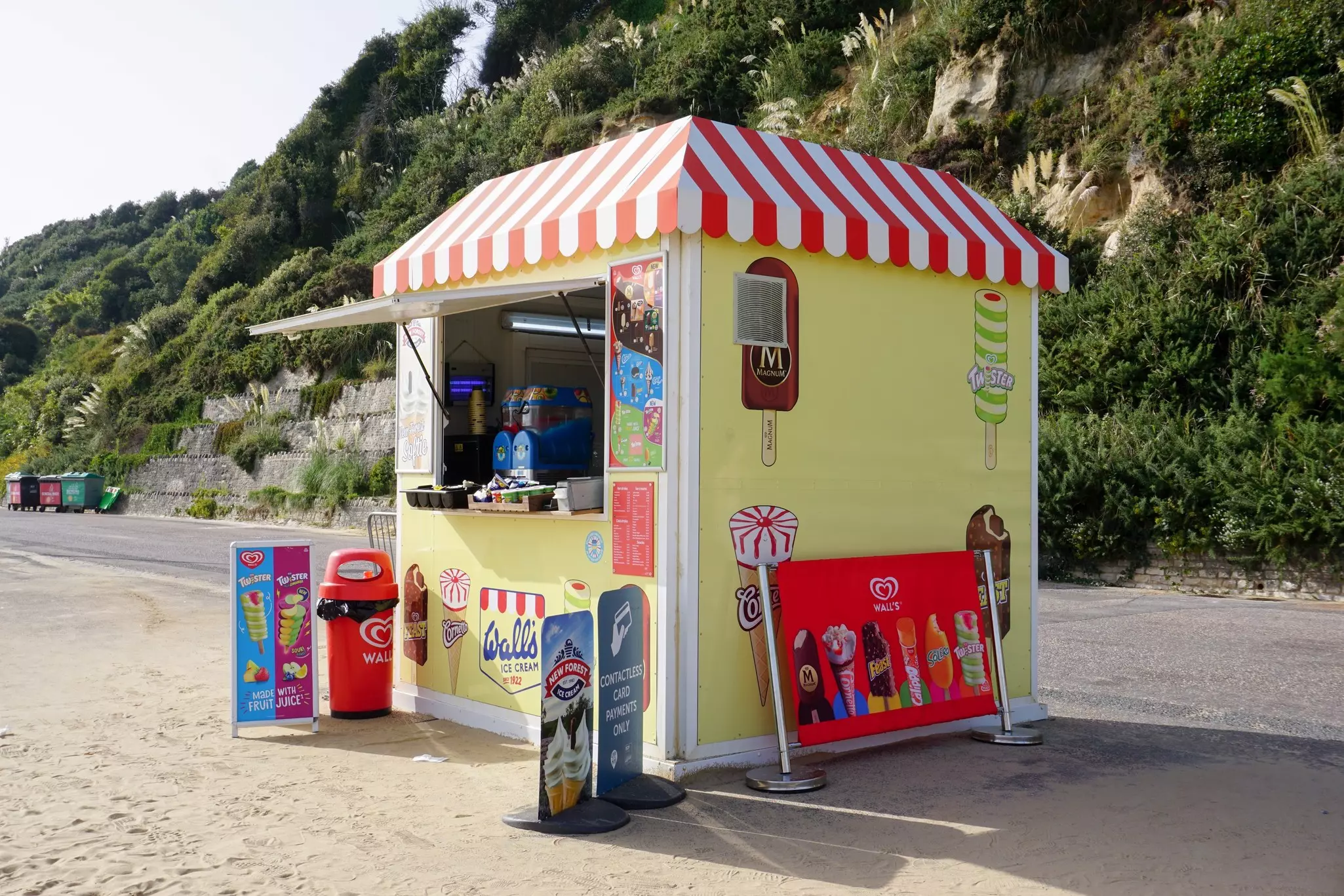 A cream-colored cabin with a green roof at Jellystone Park in Western New York