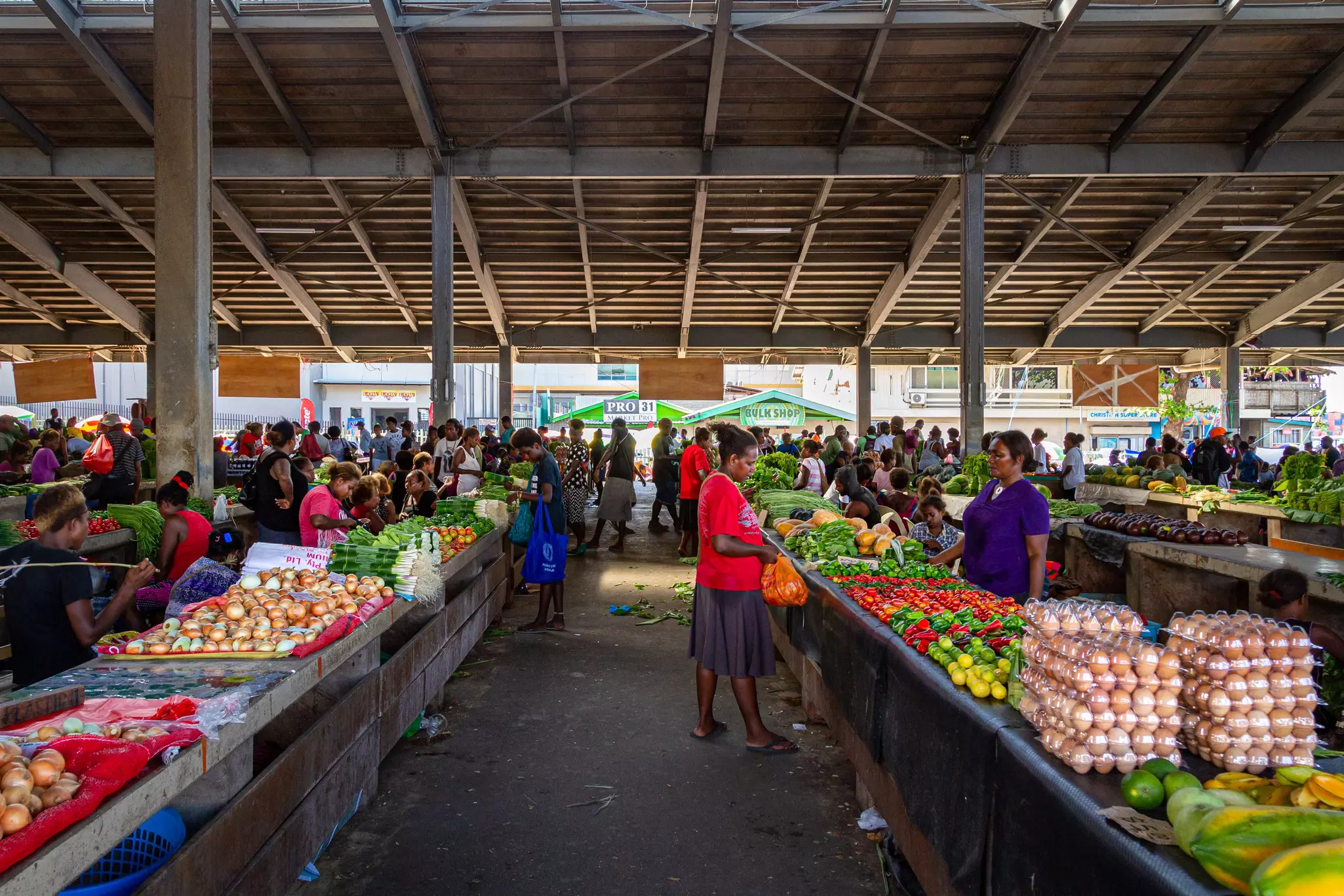 Shoppers buying fresh food in a covered market