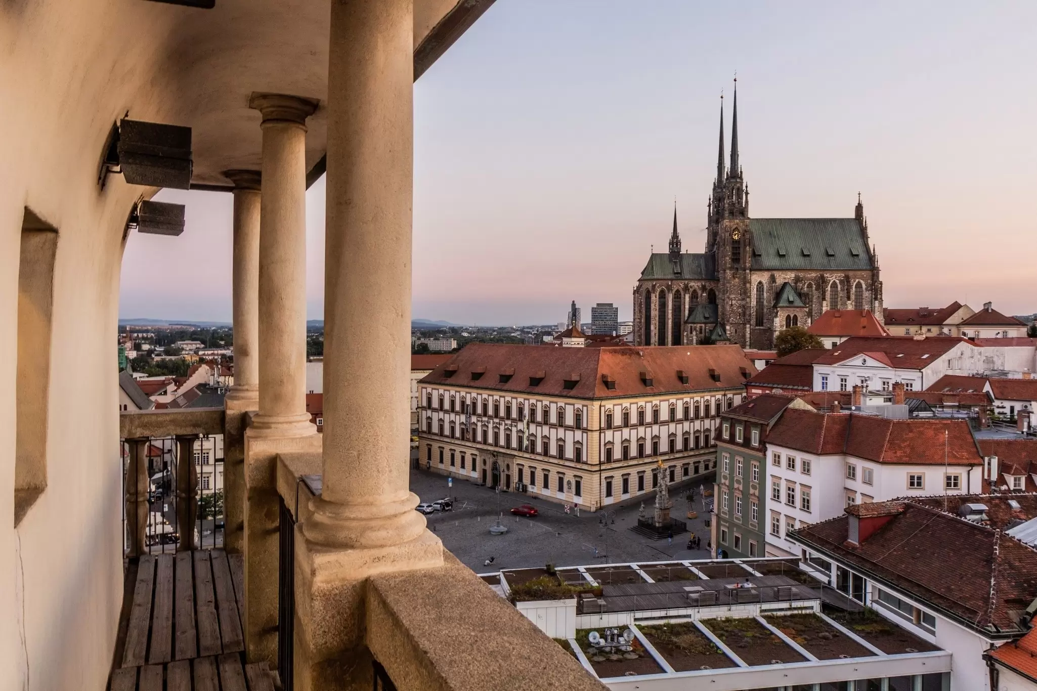 A cathedral is seen rising over other buildings in a city.