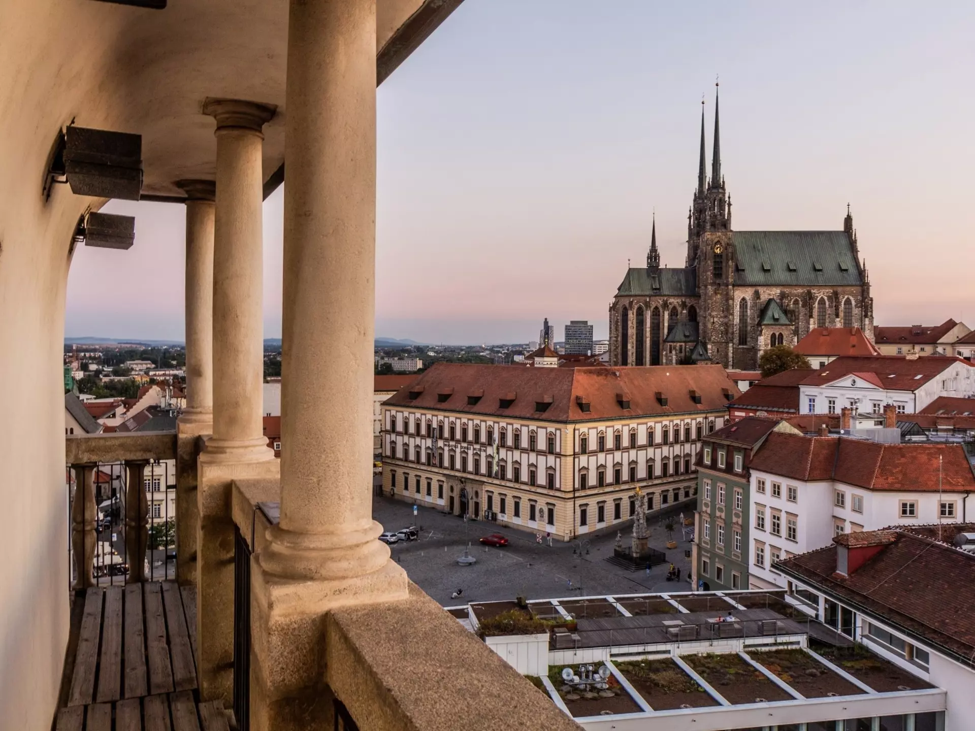 A cathedral is seen rising over other buildings in a city.