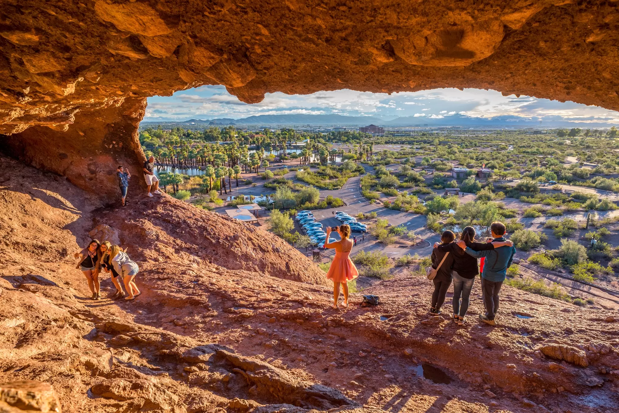 People snap pictures of themselves in the mouth of Hole-in-the-Rock, a tourist attraction in Papago Park, Arizona.