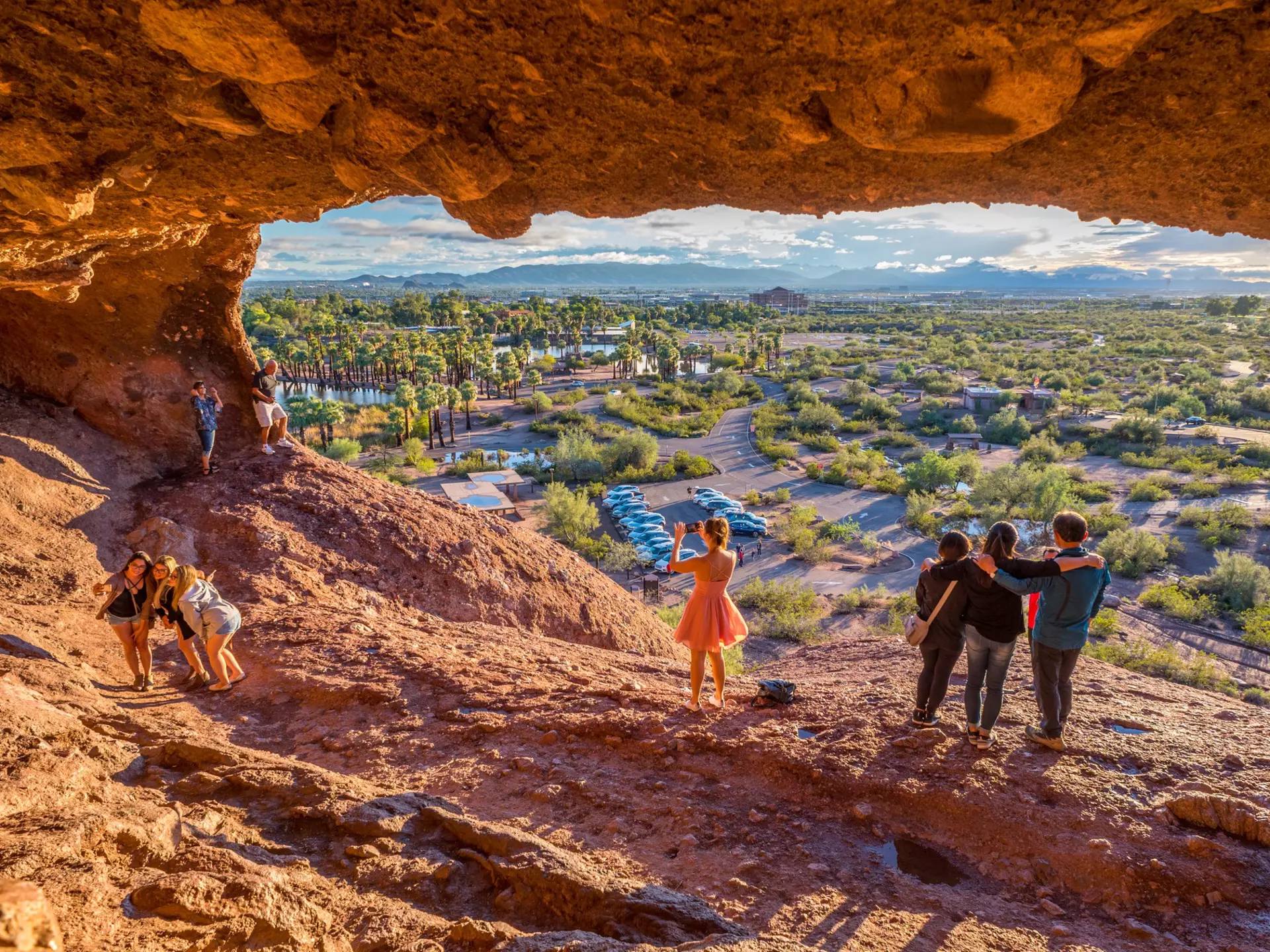 People snap pictures of themselves in the mouth of Hole-in-the-Rock, a tourist attraction in Papago Park, Arizona.