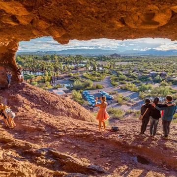People snap pictures of themselves in the mouth of Hole-in-the-Rock, a tourist attraction in Papago Park, Arizona.