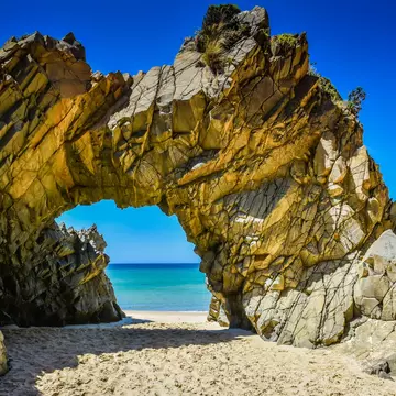 The Arch is a distinctive rock formation located at the west end of Mile Beach at the north end of The Neck that separates the north and south half of Bruny Island, Tasmania, Australia.