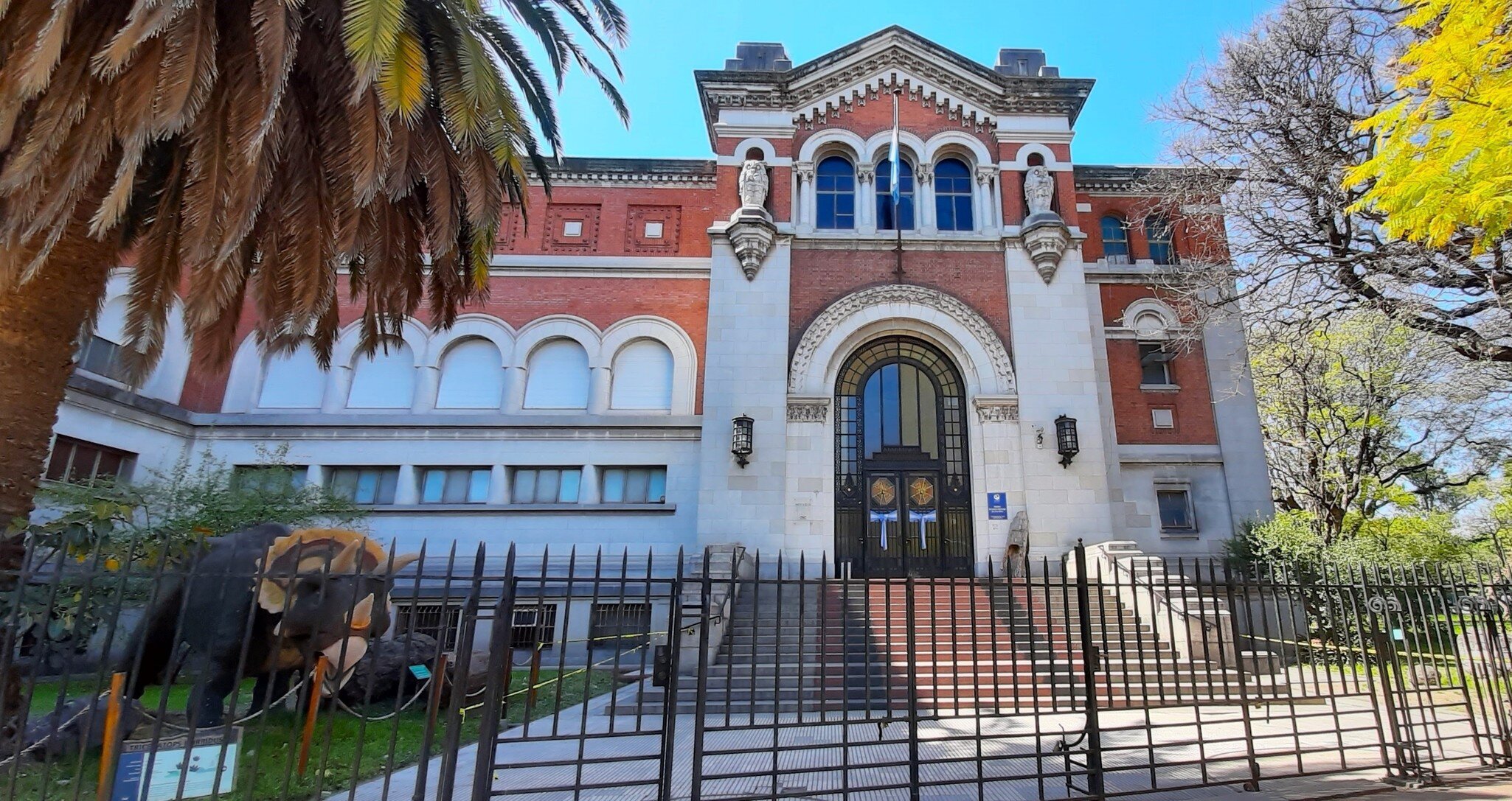 Front view of the Museum of Natural Sciences (Museo Argentino de Ciencias Naturales) located in Parque Centenario, with vegetation and blue sky. Buenos Aires, Argentina.