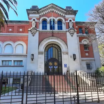 Front view of the Museum of Natural Sciences (Museo Argentino de Ciencias Naturales) located in Parque Centenario, with vegetation and blue sky. Buenos Aires, Argentina.