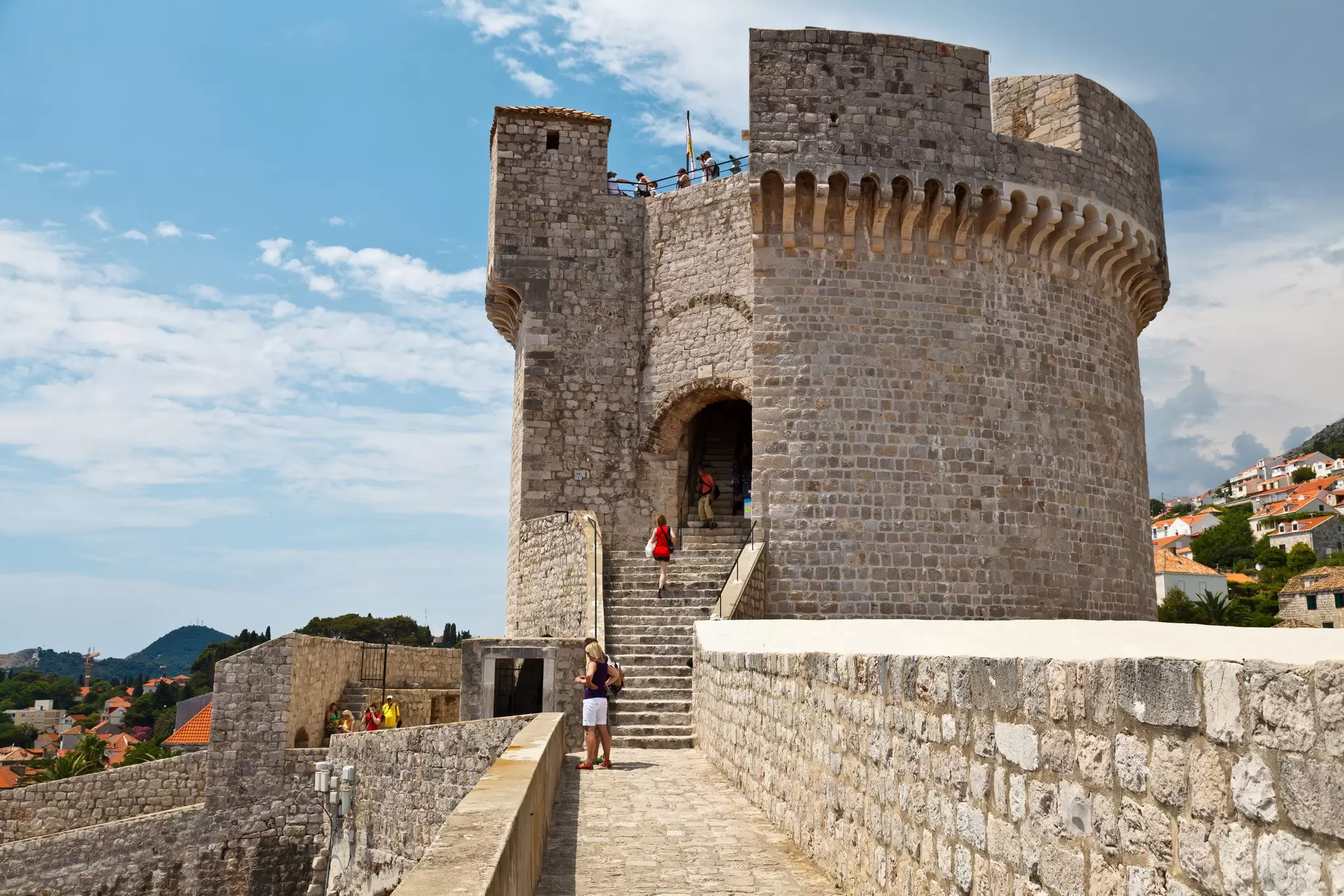 A huge round stone tower on the corner of city walls