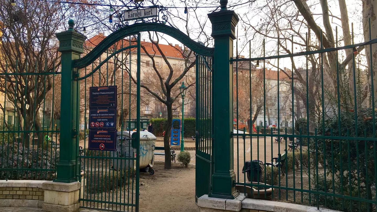 One of the front wrought-iron gates is ajar at Károly Garden, Budapest, Hungary