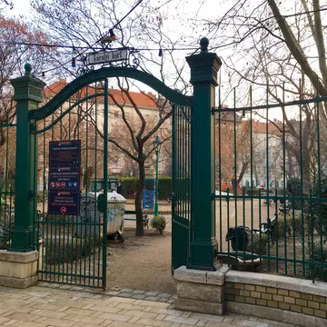 One of the front wrought-iron gates is ajar at Károly Garden, Budapest, Hungary