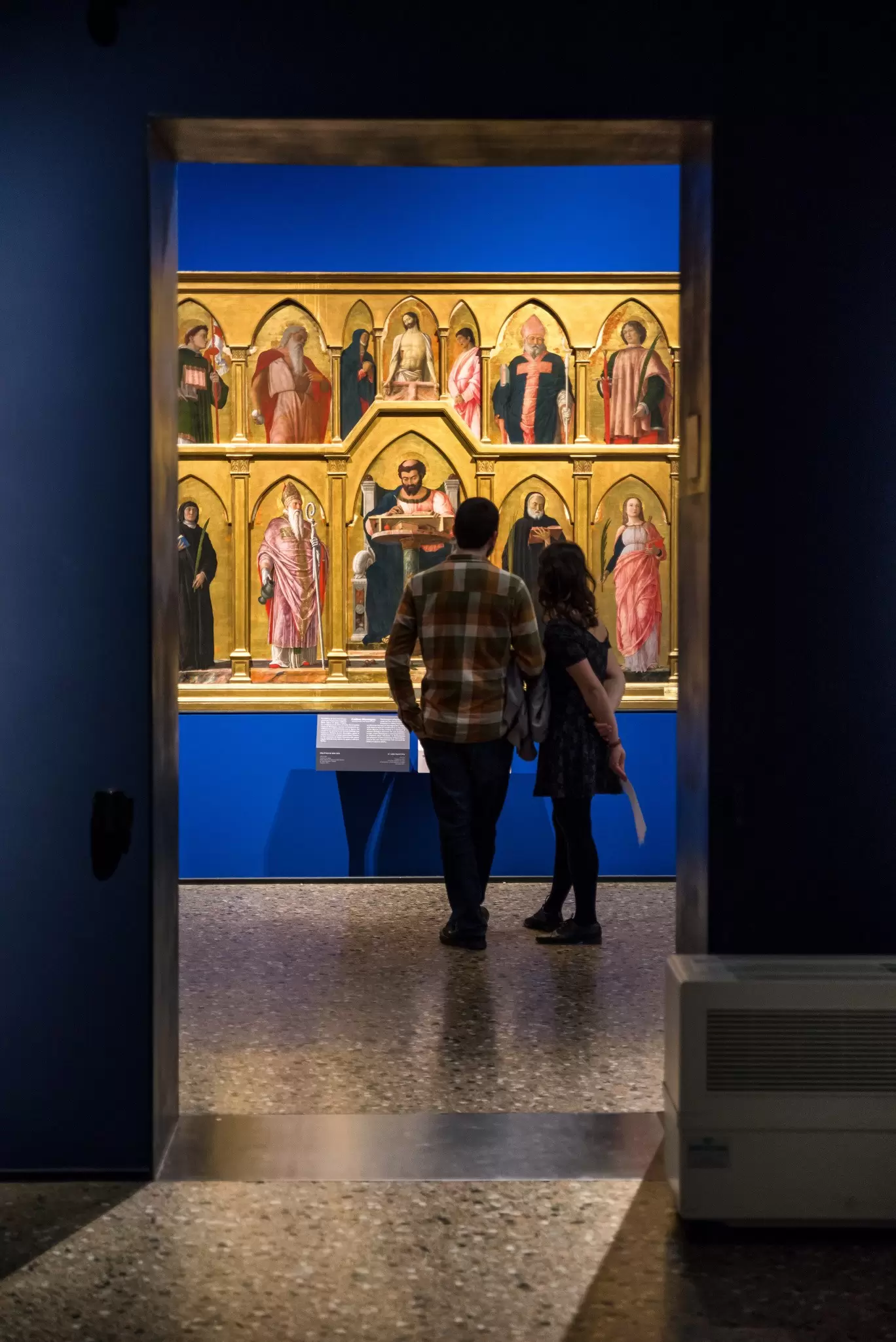 Visitors observing the artwork at the Pinacoteca di Brera.
