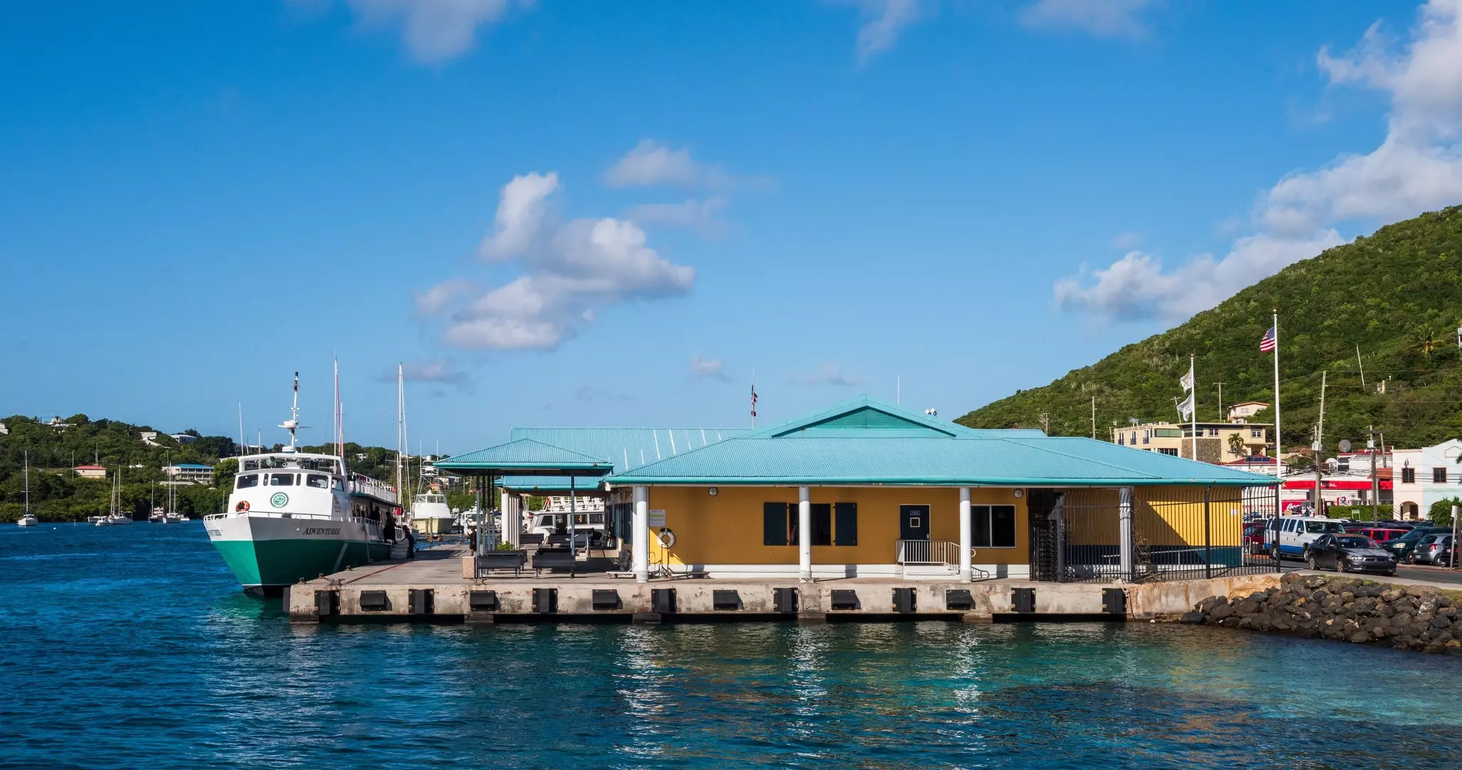 A view of the Red Hook ferry terminal on deep blue water.