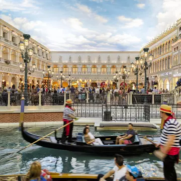 View of Grand Canal Shoppes at the Venetian Resort Hotel and Casino, gondolier and tourists on gondolas are seen in the foreground, Las Vegas, Nevada, USA
851155566
