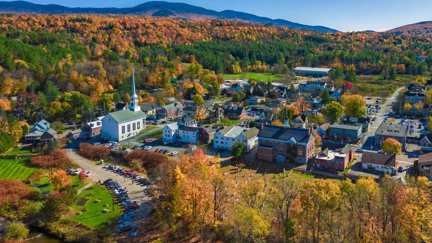 Aerial view of charming small town Stowe in Vermont. Mountains with fall multicolor trees
