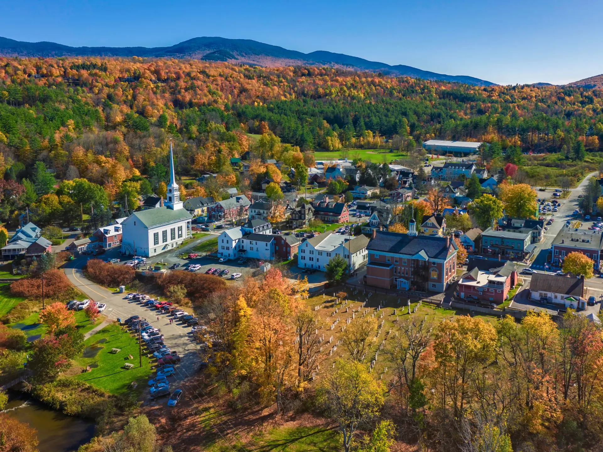 Aerial view of charming small town Stowe in Vermont. Mountains with fall multicolor trees