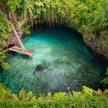 Aerial of To-Sua Ocean (giant swimming hole) in the rainforest in Samoa