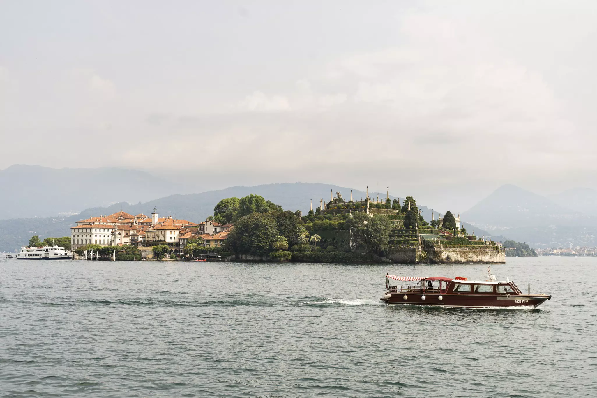 A passenger boat passes Isola Bella in Lake Maggiore, Italy.