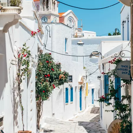 Details and streets of village of Pyrgos with Cycladic houses and the bougainvillea flowers.