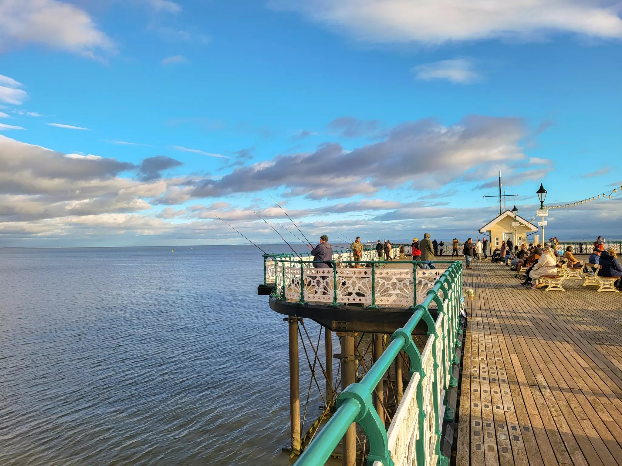 Fishers with fishing gear set up on a Victorian-era pier