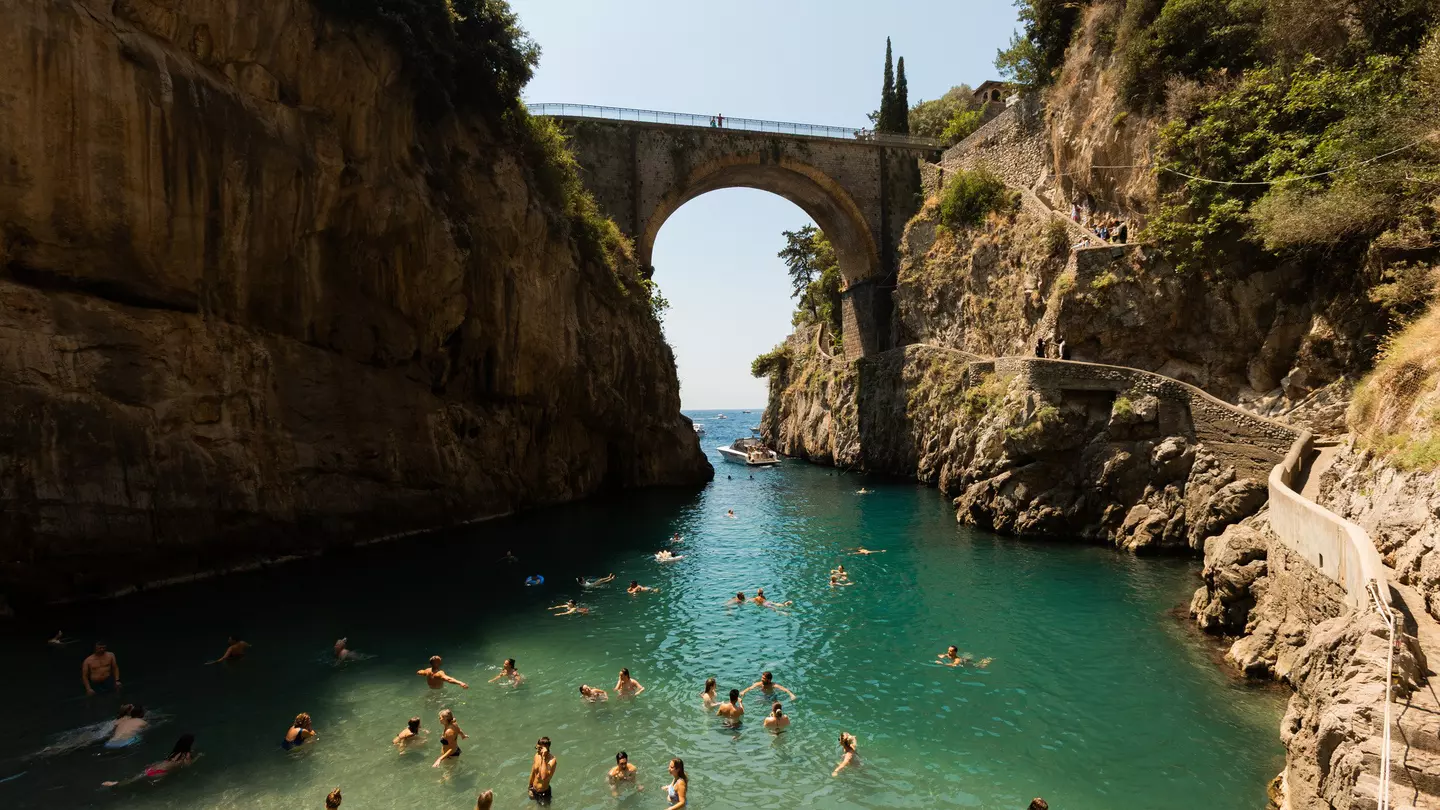 People swimming in the Furore Fjord or the Fiordo di Furore, the Amalfi Coast, July 2025.