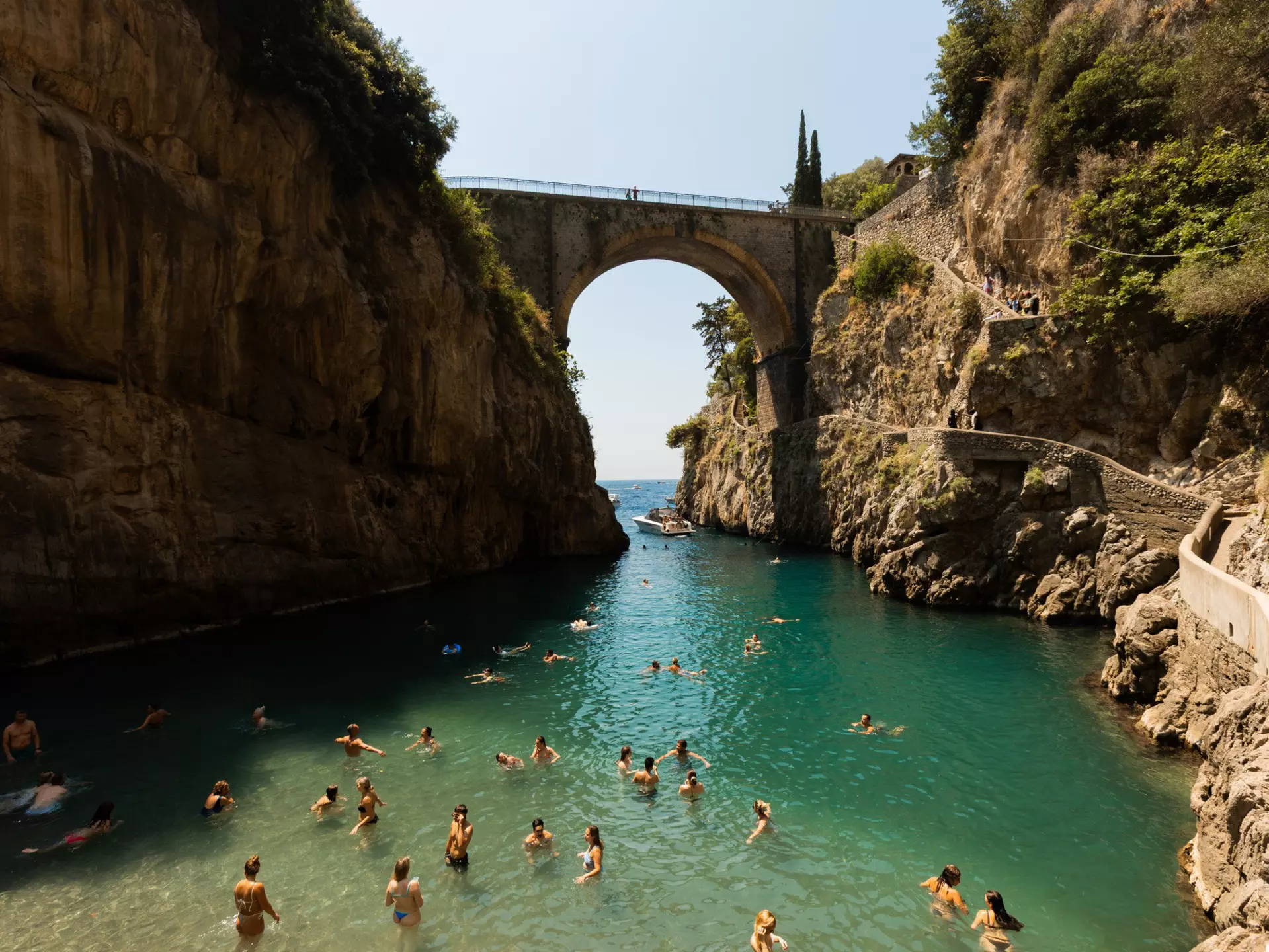 People swimming in the Furore Fjord or the Fiordo di Furore, the Amalfi Coast, July 2025.