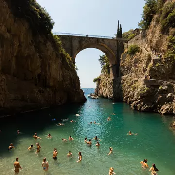 People swimming in the Furore Fjord or the Fiordo di Furore, the Amalfi Coast, July 2025.