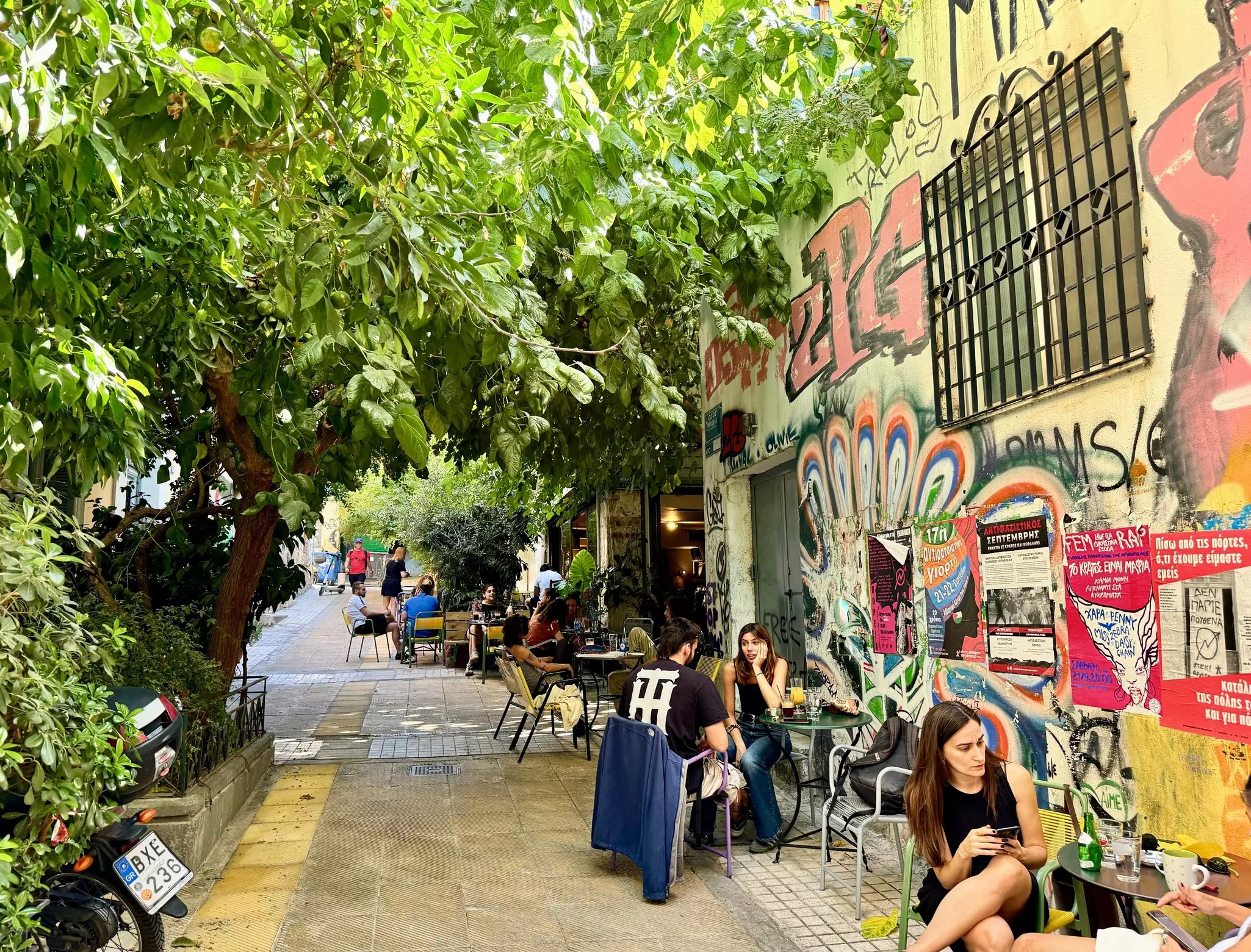 Athens, Greece - October 2, 2024 : People sitting and drinking at an outdoor cafe on Methonis pedestrian street in Exarcheia (Exarchia), Athens, Greece, License Type: media, Download Time: 2025-04-29T19:16:35.000Z, User: bhealy950, Editorial: true, purchase_order: 65050 - Digital Destinations and Articles, job: Lonely Planet Online Editorial, client: Best things to do in Athens, other: Brian Healy