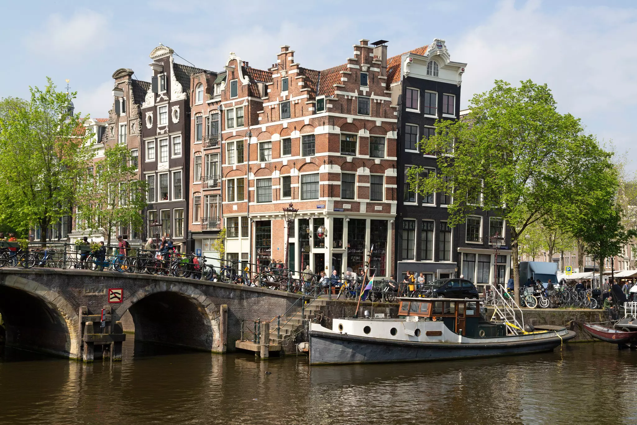 Connected brick buildings above a canal