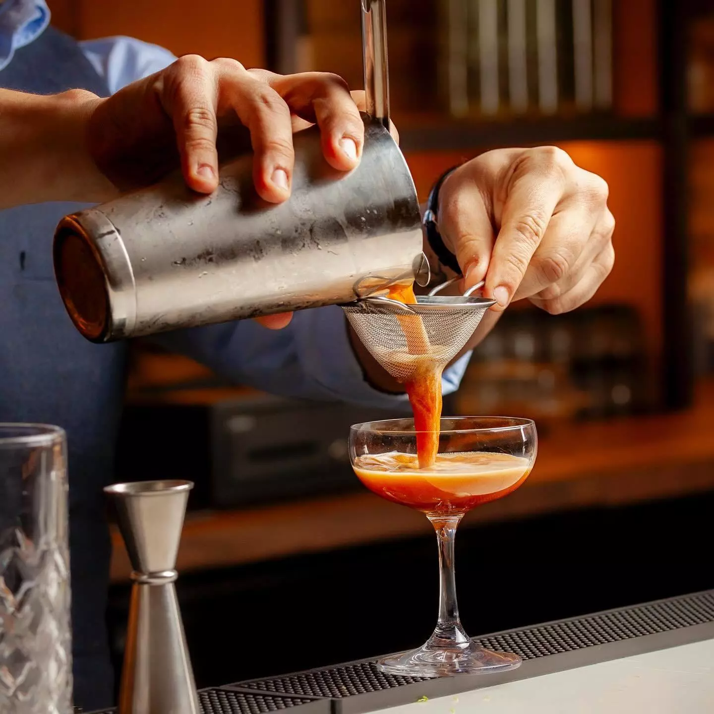 A bartender makes a zero-proof cocktail at No More Cafe