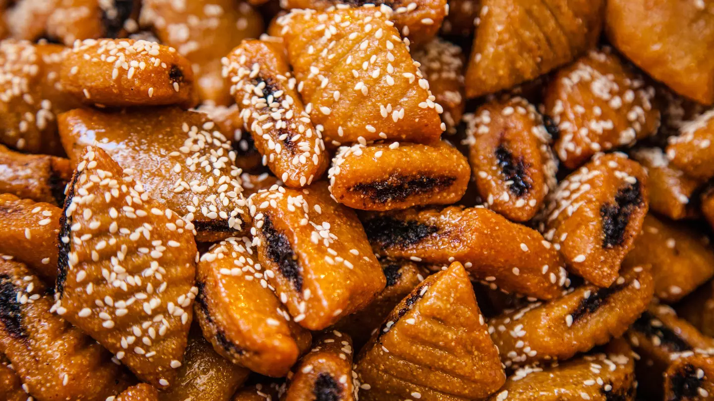 Close-up of makroudh, traditional Tunisian sweets, mainly made of durum wheat semolina, olive oil, dates, then deep fried in oil and soaked in honey syrup.