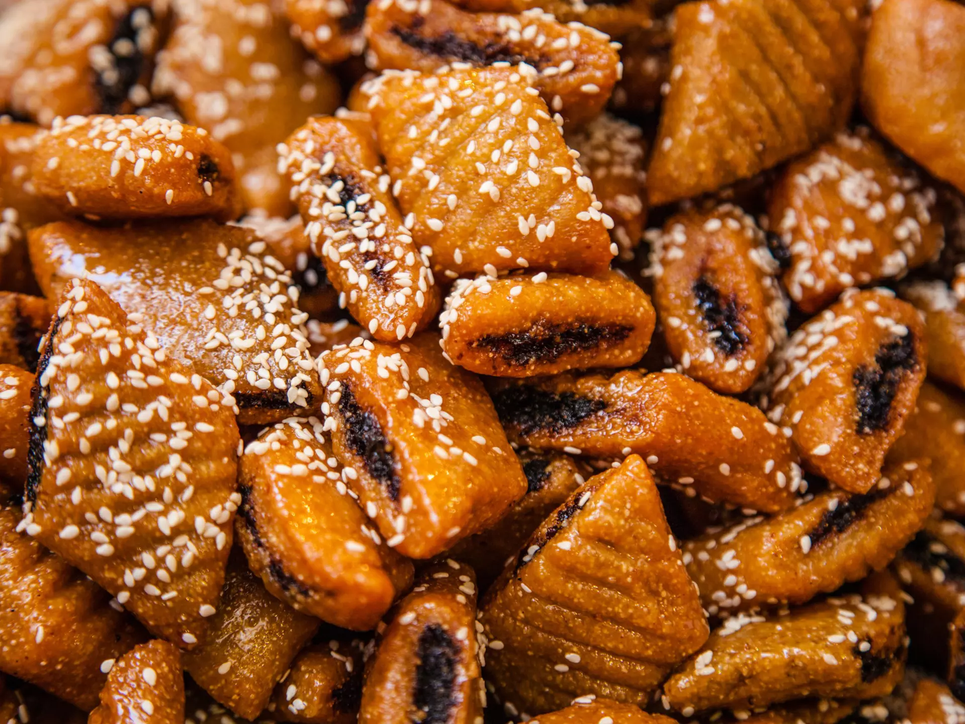 Close-up of makroudh, traditional Tunisian sweets, mainly made of durum wheat semolina, olive oil, dates, then deep fried in oil and soaked in honey syrup.