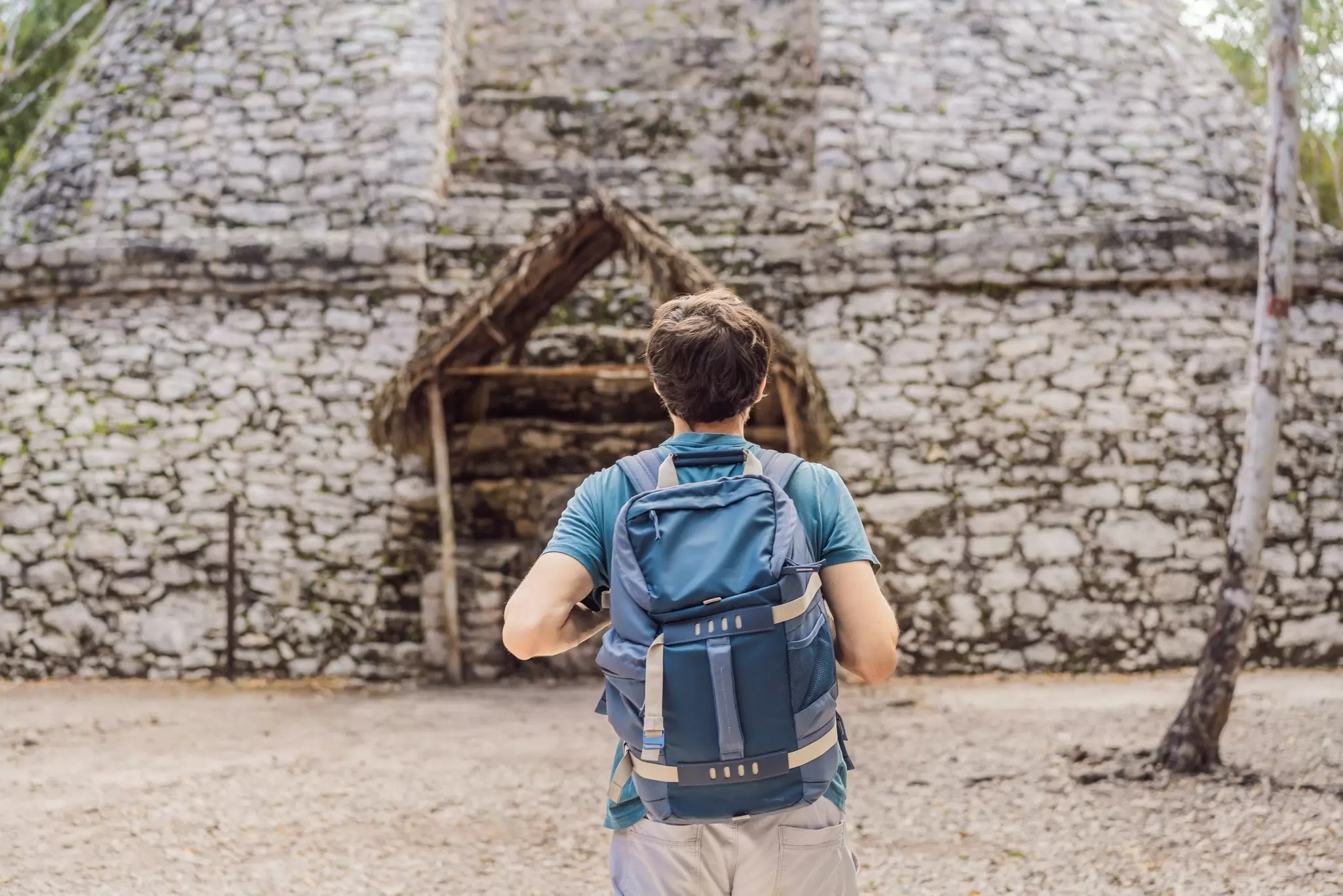 Man tourist at Coba, Mexico. Ancient mayan city in Mexico. Coba is an archaeological area and a famous landmark of Yucatan Peninsula. Cloudy sky over a pyramid in Mexico, License Type: media, Download Time: 2025-05-28T09:23:53.000Z, User: lonelyplanetmedia, Editorial: false, purchase_order: 65050 - Digital Destinations and Articles, job: Global Publishing WIP, client: Global Publishing WIP, other: Peterson Haggarty // SS Comp Ingestion