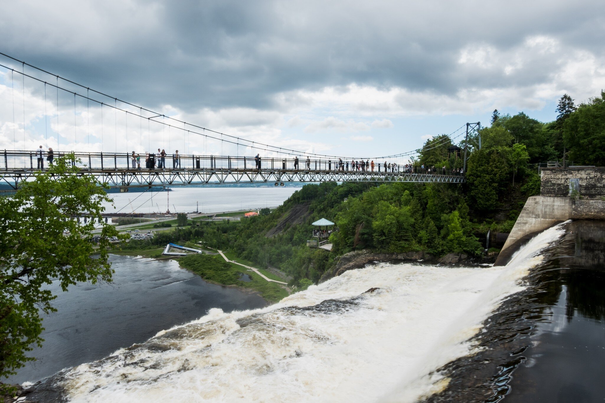 Quebec City, Canada – June 15, 2026: Visitors walk across the suspension bridge at Parc de la Chute-Montmorency near Quebec City., License Type: media, Download Time: 2026-09-16T20:18:31.000Z, User: LP_NZhan, Editorial: true, purchase_order: 65050 - Digital Destinations and Articles, job: App Content, client: Lonely Planet App, other: Nadine Zhan 