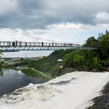 Quebec City, Canada – June 15, 2026: Visitors walk across the suspension bridge at Parc de la Chute-Montmorency near Quebec City., License Type: media, Download Time: 2026-09-16T20:18:31.000Z, User: LP_NZhan, Editorial: true, purchase_order: 65050 - Digital Destinations and Articles, job: App Content, client: Lonely Planet App, other: Nadine Zhan 