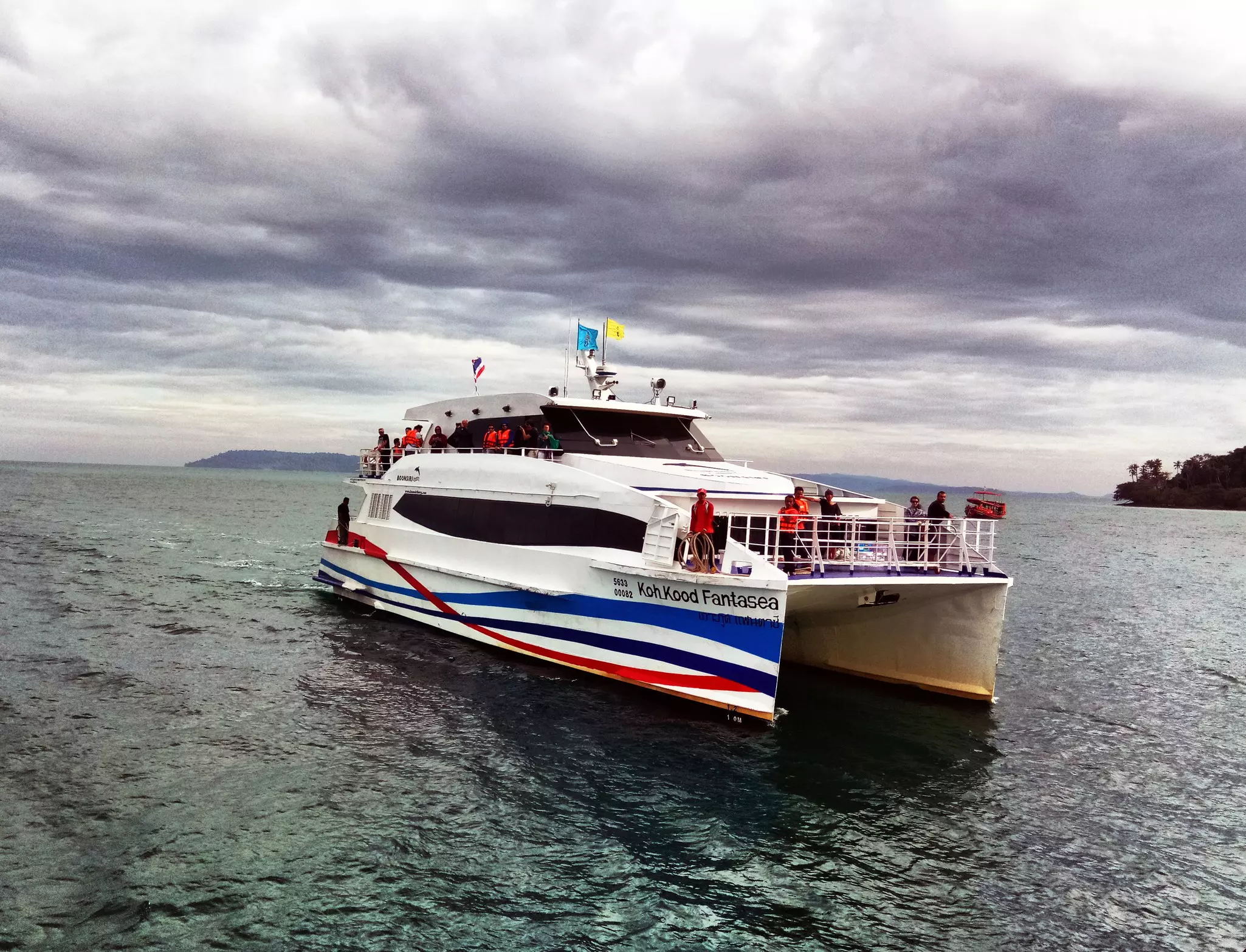 A hydrofoil ferry is pictured in the water on an overcast day.