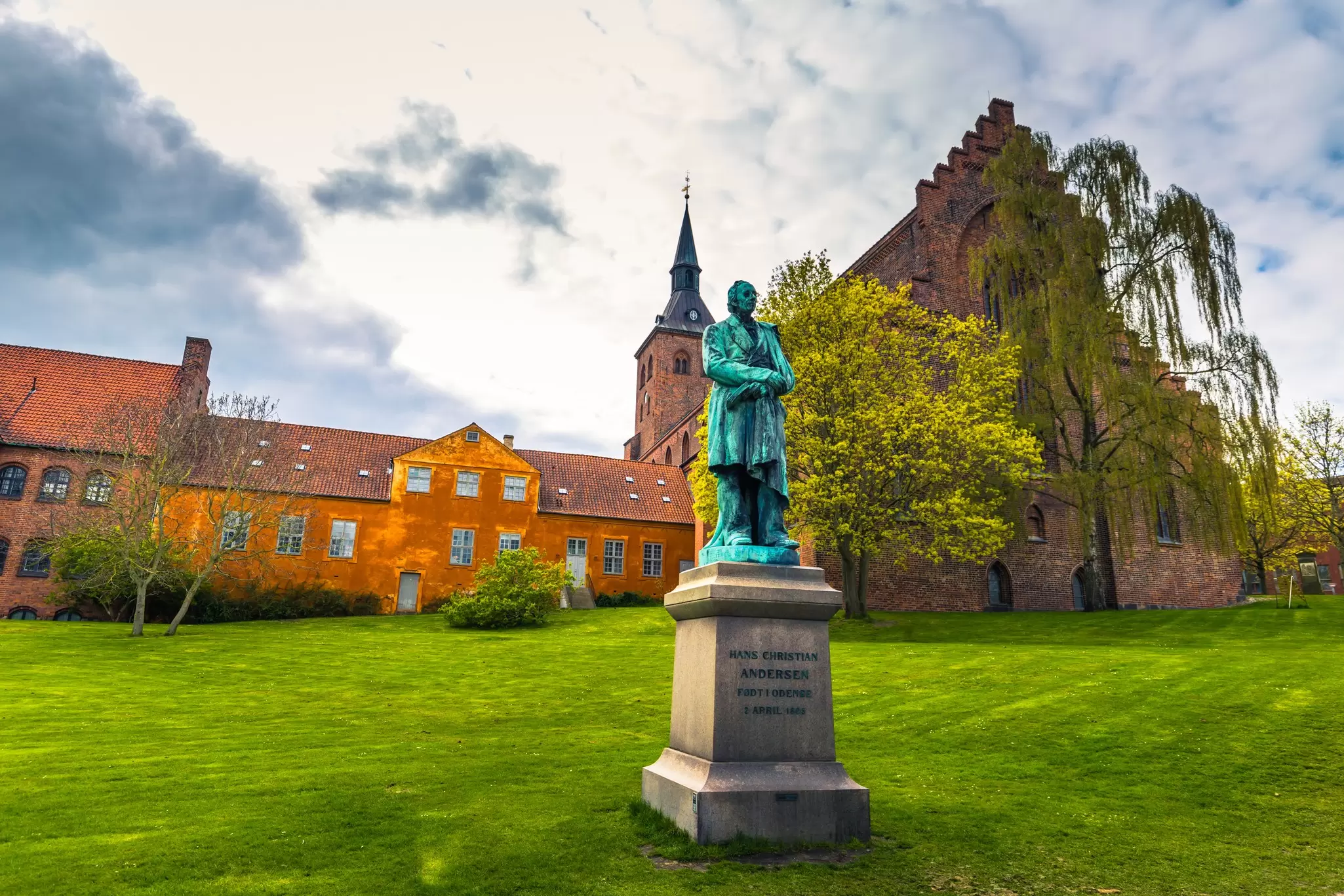 A statue of Hans Christian Andersen in a field behind the Domkirke, Odense, Denmark. RPBaiao/Shutterstock