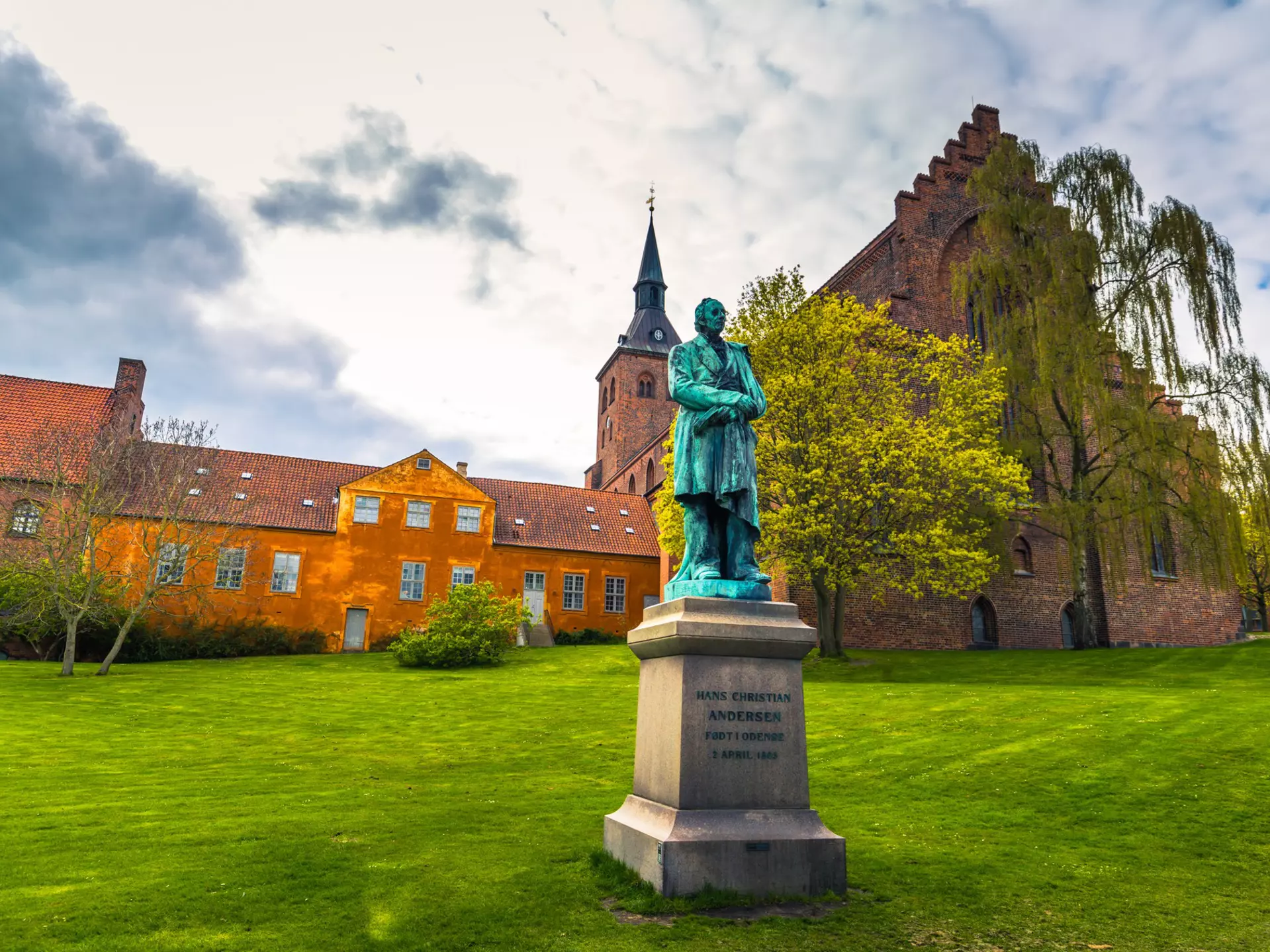 A statue of Hans Christian Andersen in a field behind the Domkirke, Odense, Denmark. RPBaiao/Shutterstock