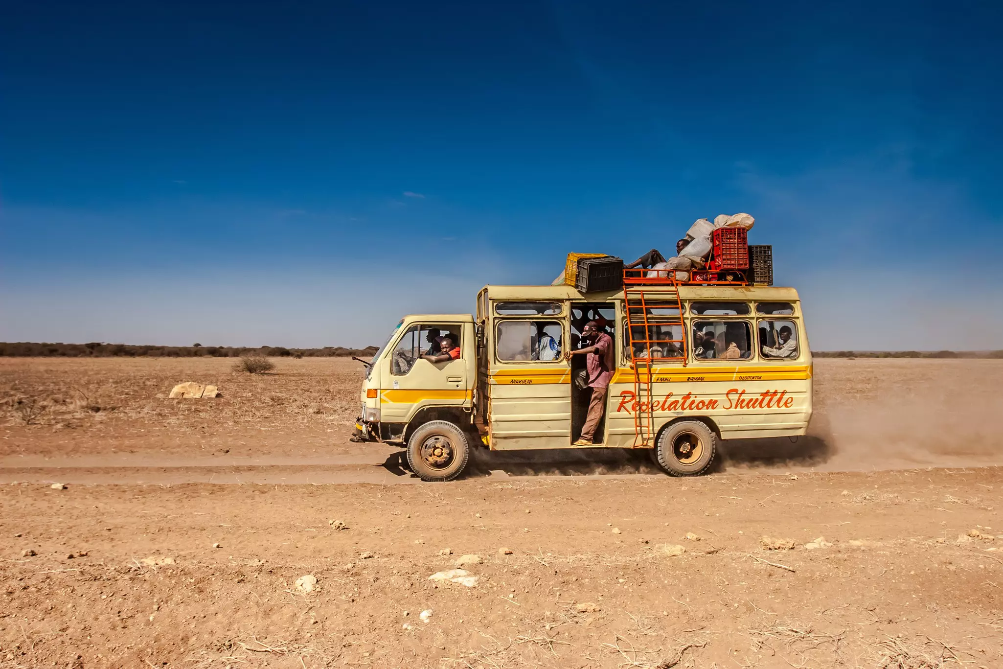 A rural bus on a dirt road in Kenya.
