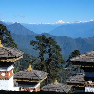 Chortens (stupas) on Dochu La sit to a stunning backdrop of Himalayan views. Peter Salaj / Shutterstock